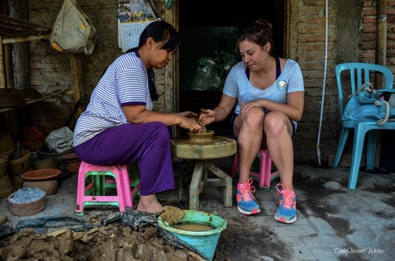 Christina making clay, learning from a sculptor near Borobudur, Indonesia