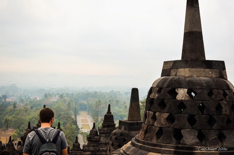 Duke Stewart standing next to a Borobudur Stupa, Indonesia