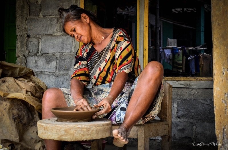 A woman making clay bowls in Indonesia