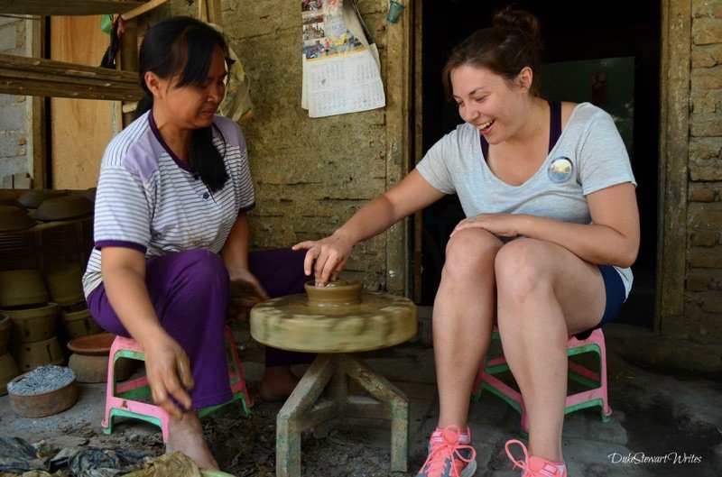 Christina making pottery at a clay village near Borobudur Temple in Indonesia