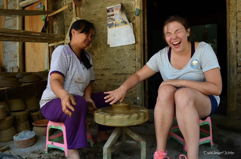 Christina making pottery at a clay village near Borobudur Temple in Indonesia