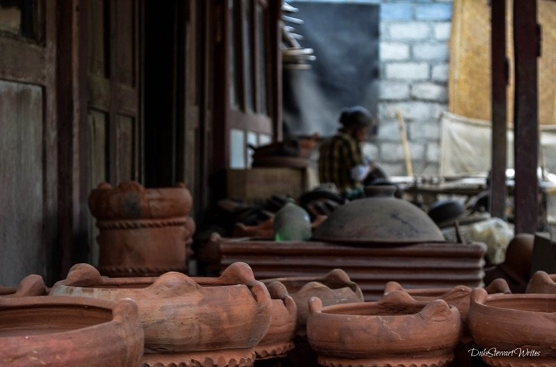 Clay Pots and a Woman making them in the background, Indonesia