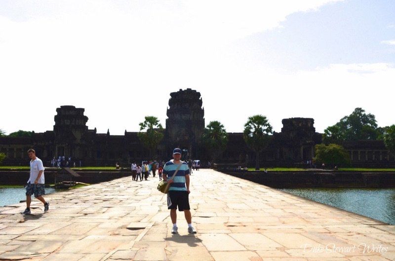 Duke Stewart Standing in front of the exterior wall as we walk across the Angkor Wat moat