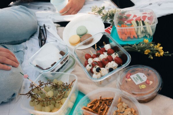 Healthy travel snacks including fresh fruit, almonds, and whole-grain crackers